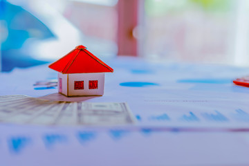 Model house for sale and graphs. Real estate concept.