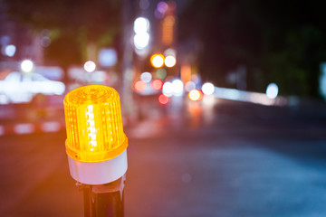 Indicator light of construction zone on the road of the night city.