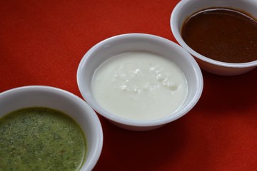 Coriander chutney and tamarind chutney with curd.