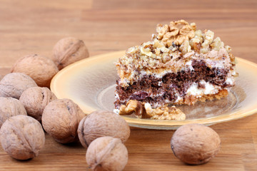 portion of white and brown chocolate walnut cake with walnuts