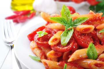 Pasta, penne with tomato sauce and basil
