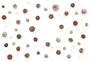 Silver christmas decorations, silver pine cone on white background. Flat lay, top view. Christmas pattern