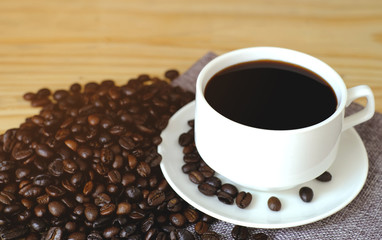 black espresso with coffee bean on wood table