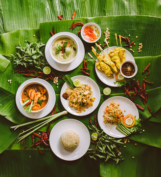 Variety of authentic thai traditional meal set on green banana leaves