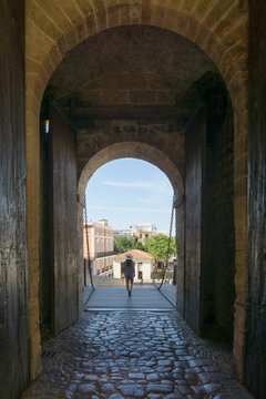 Young woman in the main entrance gate of Dalt Vila in Ibiza