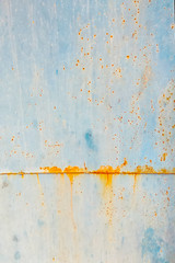 Old worn metal surface with paint.  Metal sheet with rust and worn blue paint. Background.