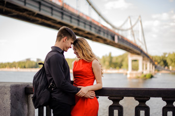 Fototapeta premium Smiling couple on the background of the bridge