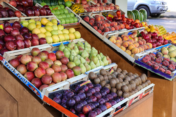 Variety of fresh fruits on the counter in the greek grocery store.