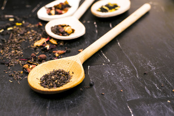 Tea in wooden spoons, lemon