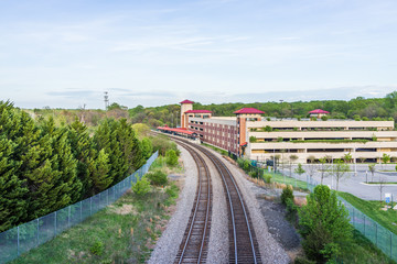 Fototapeta premium Aerial view of Burke Centre train station with railroad and parking lot building