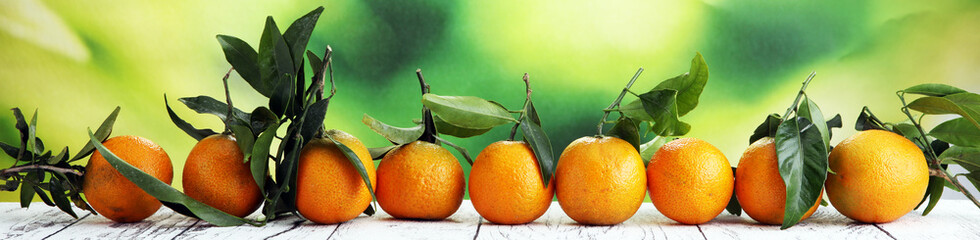 Tangerines with leaves on wooden background. Mandarins Rustic style