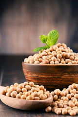 Composition with bowl of soya beans on wooden table
