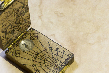 A sundial with a compass in brown background