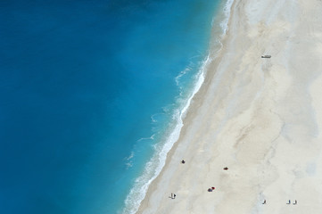 Sunbathers on the bone-white sands of Kefalonia's Myrtos beach considered one of the most beautiful in all the Greek islands.