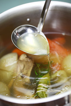 making chicken soup stock (bouillon) in a pot
