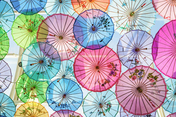 Roof decorated by colorful handmade umbrellas made from paper for protecting sunlight from outside.