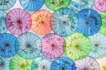 Roof decorated by colorful handmade umbrellas made from paper for protecting sunlight from outside.