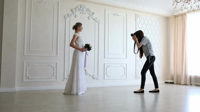 Photographer taking pictures the young sexy bride