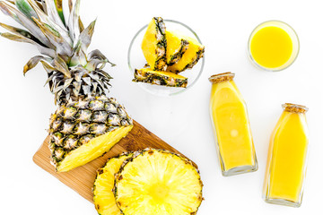 Preparing pineapple juice. Cut slices of pineapple. White background top view