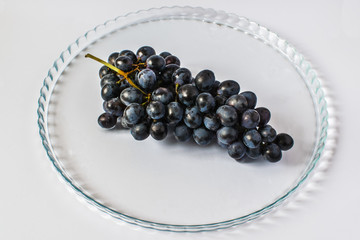 Dark grapes on a beautiful tray