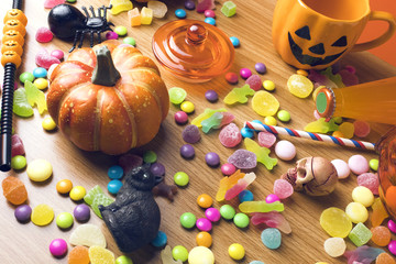 colorful halloween candy dessert party on wood ground