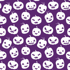 Vector seamless pattern with Halloween pumpkin silhouettes in white color with carved faces on purple background for scrapbook, invitations and textile