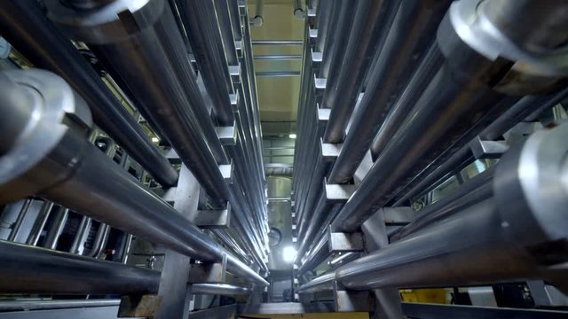 Bent pipes forming a double-sided corridor at a dairy factory. 
