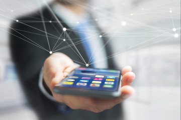 Hand of a businessman holding smartphone with operating system screen and network connection