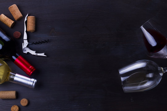 Bottle of red wine and two wine glasses on table with copy space