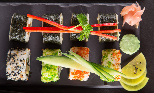 Japanese sushi set on a rustic dark background.