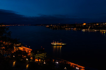 Fototapeta premium Cityscape or skyline aerial view of Saint Lawrence river and Levis with illuminated ferry at night