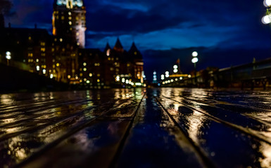 Fototapeta na wymiar Old town closeup view of wet dufferin terrace at night with Chateau Frontenac