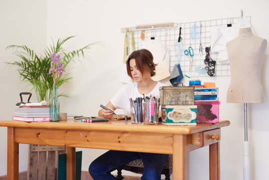 a young woman creating a handmade bag