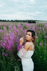 Beautiful woman in a field of pink flowers.