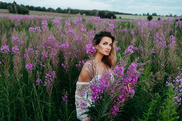 Beautiful woman in a field of pink flowers.