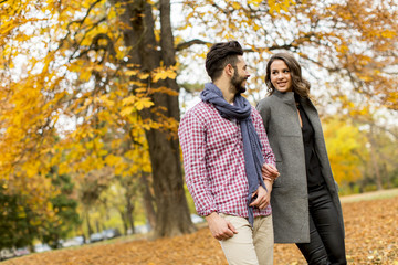 Lovely young couple in the autumn forest