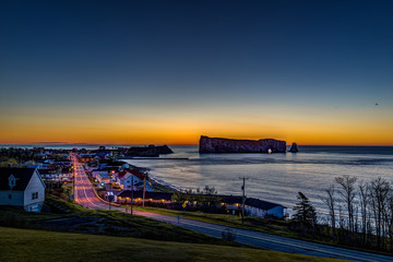 Famous Rocher Perce rock in Gaspe Peninsula, Quebec, Gaspesie region with cityscape at sunrise