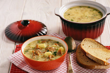 Vegetarian cuisine - soup with potatoes and chanterelles mushroom.