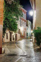 Fototapeta na wymiar Narrow old street at night in Saint-Tropez, France.