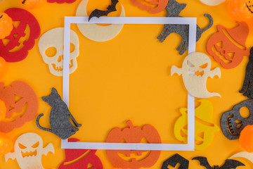 Halloween flat lay frame on orange background with copy space