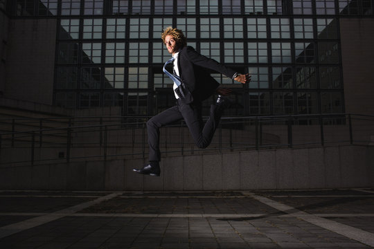 Young businessman jumping in the air