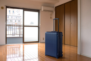 Suitcase in empty apartment room, Tokyo,...