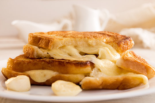 Italian toast sandwich with white bread and mozzarella cheese fried in oil. Mediterranean meal.