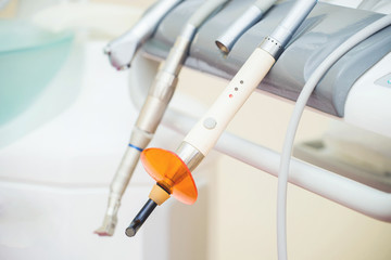 Dental UV curing light lamp . Ultraviolet polymerization lamp with Orange blocking glass. tooth care concept.