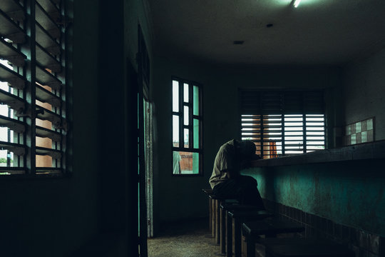 Man sleeping at counter in empty room