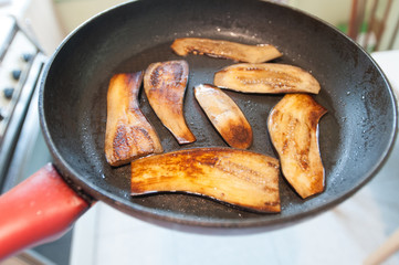 Sliced eggplant on frying pan