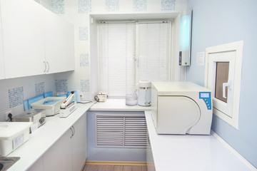 Modern sterilization room interrior, handling of dental instruments workplace.