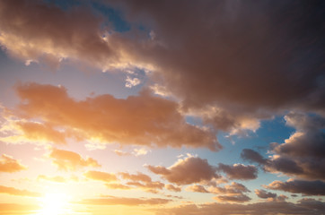 Beautiful sunset and clouds in the sky and the bright sun.