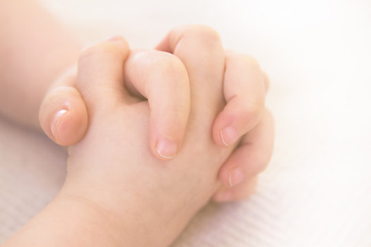 Child folding hands for prayer; praying hands