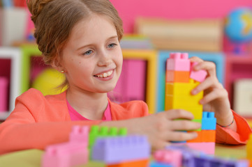 girl playing with plastic blocks